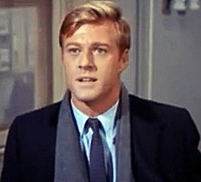 A young Robert Redford in Barefoot in the Park, wearing a suit and scarf in a 1960s film still