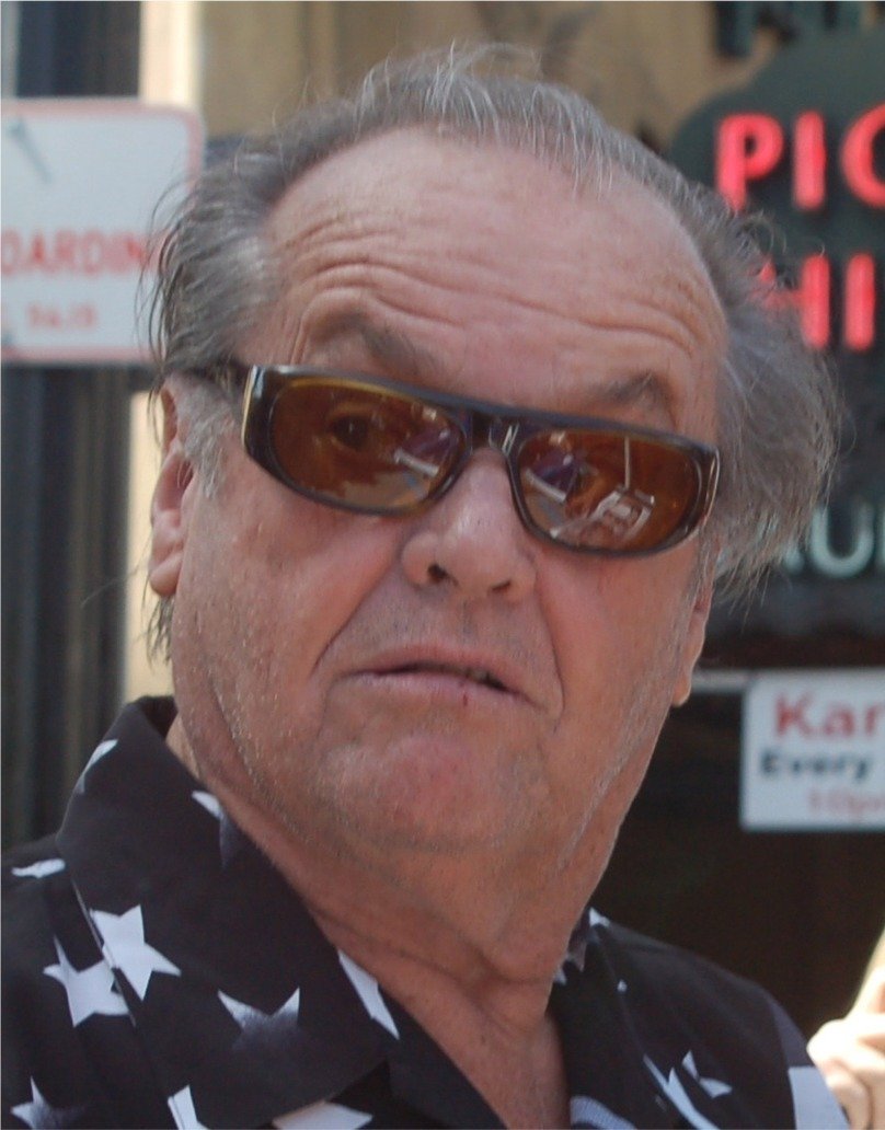 Jack Nicholson in sunglasses signing autographs at a Hollywood Walk of Fame ceremony in 2010