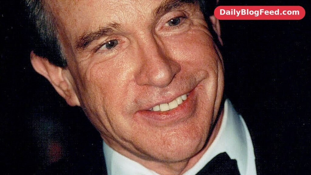 Warren Beatty smiling in a black tuxedo at a formal event in 2001