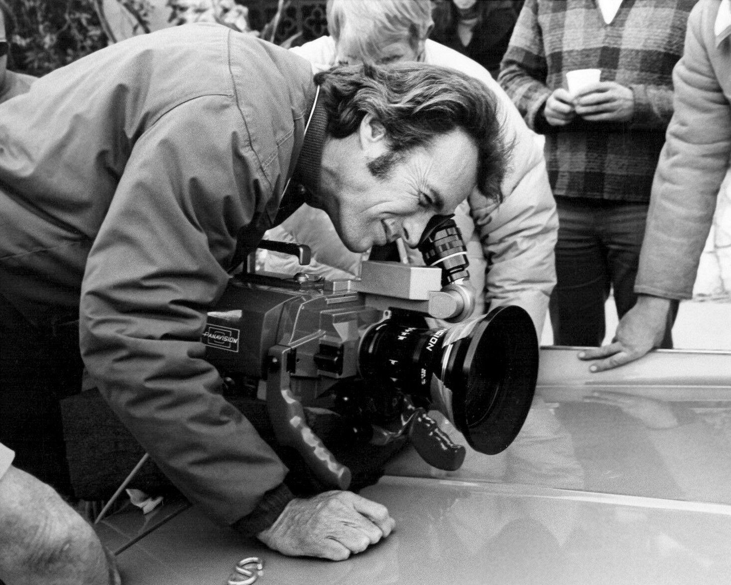 Clint Eastwood looking into the viewfinder of a Panavision camera on the set of the 1973 film Breezy, which he directed