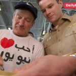 Robin Williams signing autographs for a US Navy sailor aboard the USS Enterprise in 2003