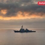 A US Navy warship patrols Gulf waters at dawn as tensions with Iran rise