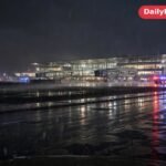 Emergency vehicles outside King Fahd International Airport in Dammam at night after the attack