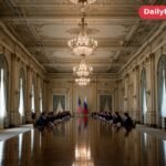 Officials seated at a long negotiating table during talks in St Petersburg