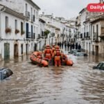 Rescue workers navigate a flooded street in eastern Spain after deadly floods